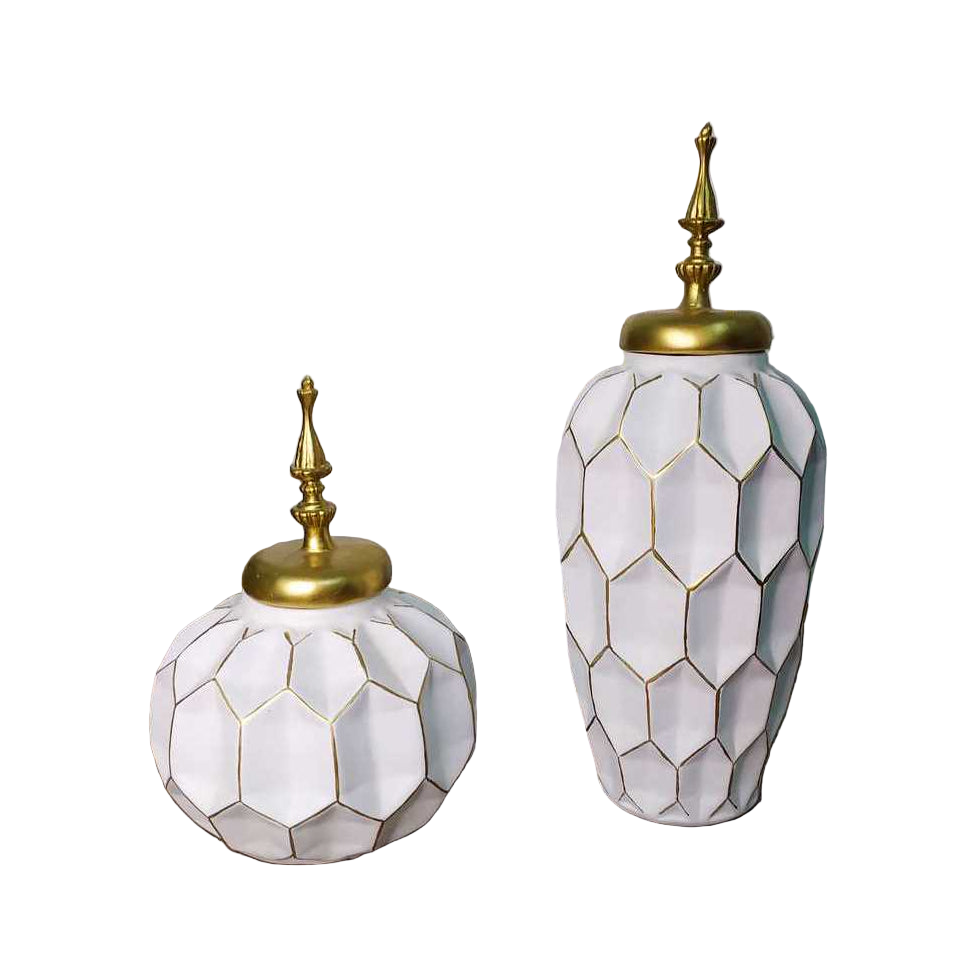 Two decorative vases with geometric patterns and gold accents on a wooden surface.