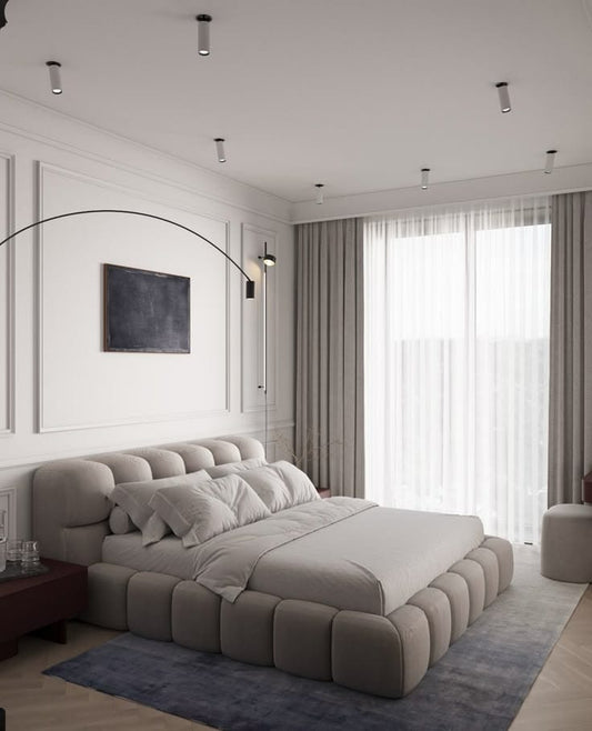 Modern bedroom with a large bed, side tables, and a window with curtains.