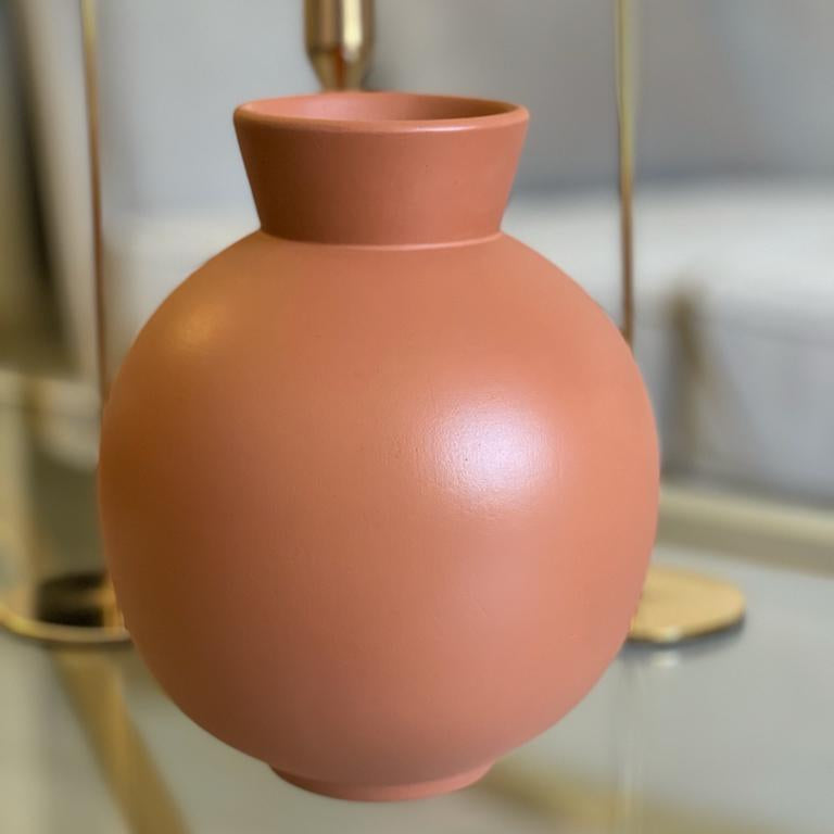 Ceramic vase with a smooth finish on a reflective surface