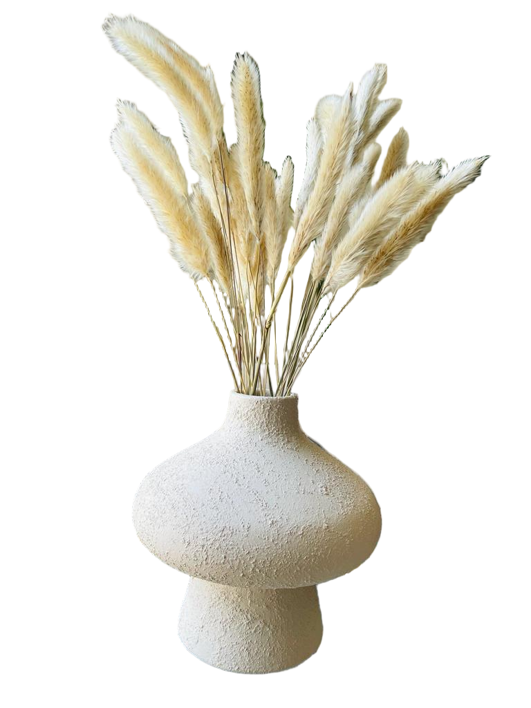 Decorative vase with dried grasses on a coffee table in a living room setting