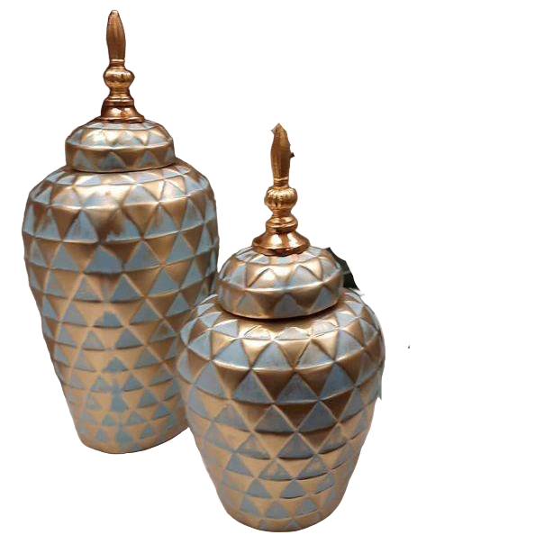 Decorative vases and candle holders with geometric patterns on a table.