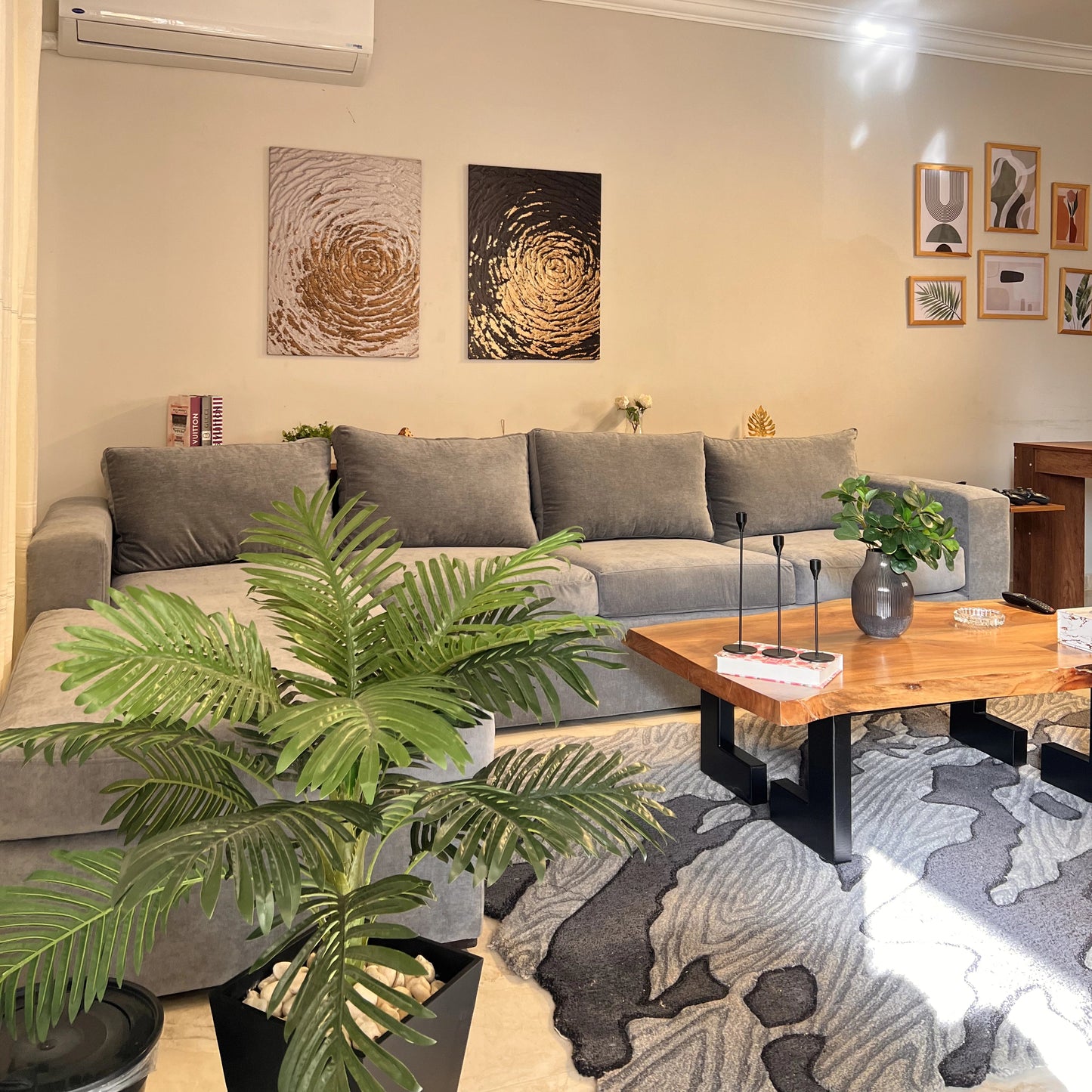 Living room with gray sofa, wooden coffee table, and decorative plants.