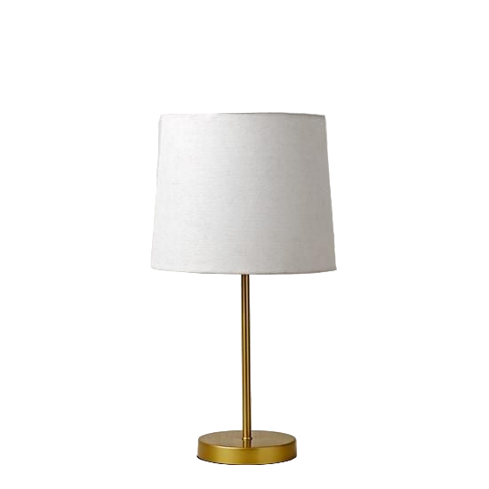 Table lamp with white shade and gold base against a white brick wall.