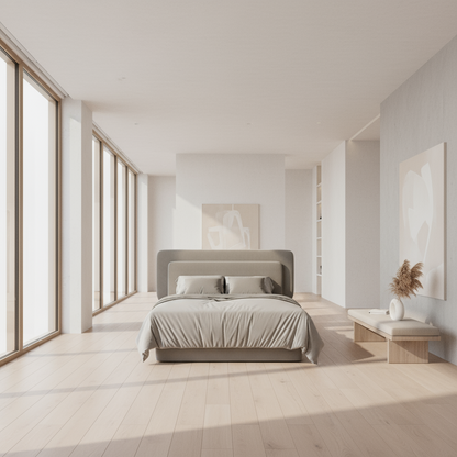 Gray upholstered bed with matching bedding on a white background