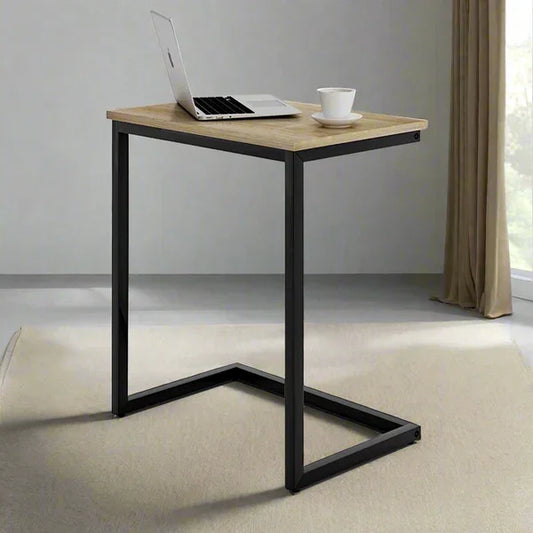 Small wooden desk with black metal legs in a minimalistic room.