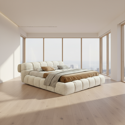 Beige upholstered bed with pillows and blankets on a white background