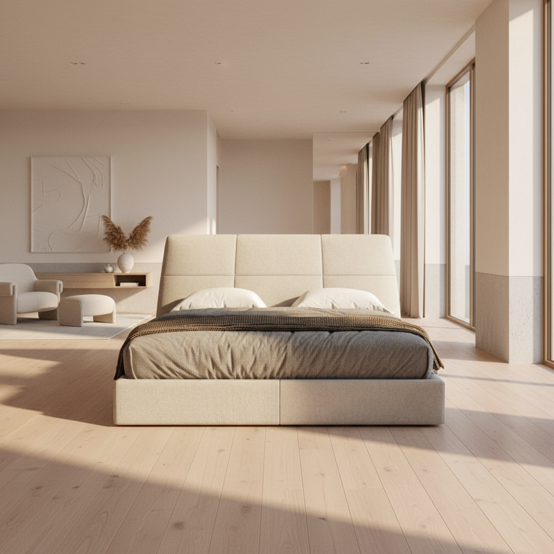 Beige upholstered bed with a brown blanket and white pillows on a white background