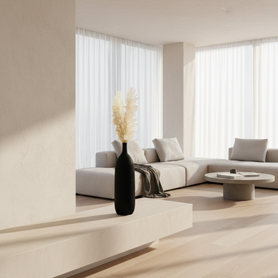 Black vase with dried pampas grass on a white background
