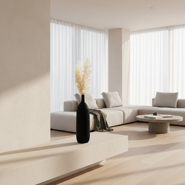 Black vase with dried pampas grass on a white background