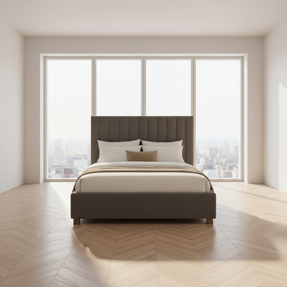 Gray upholstered bed in a stylish bedroom with a chandelier and framed artwork.