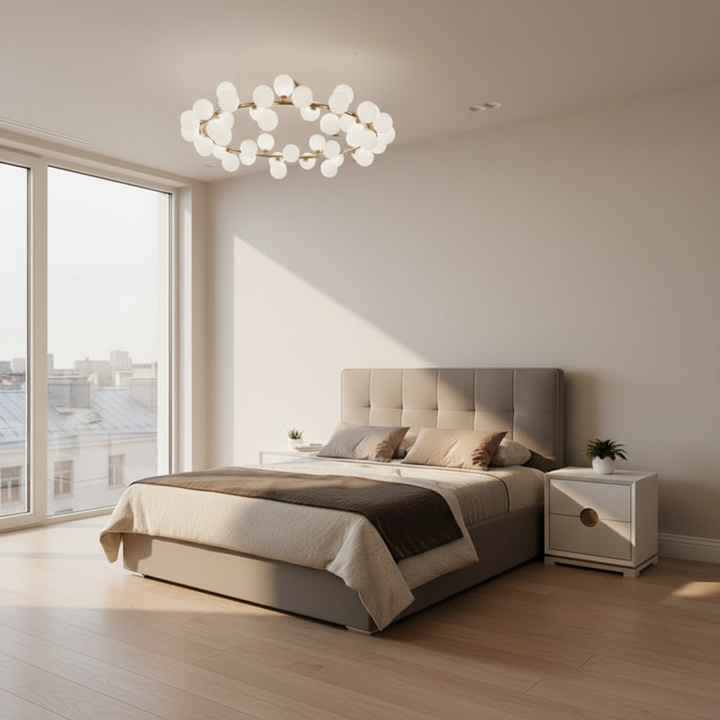 Modern bedroom with a gray upholstered bed, geometric wall design, and decorative lighting.