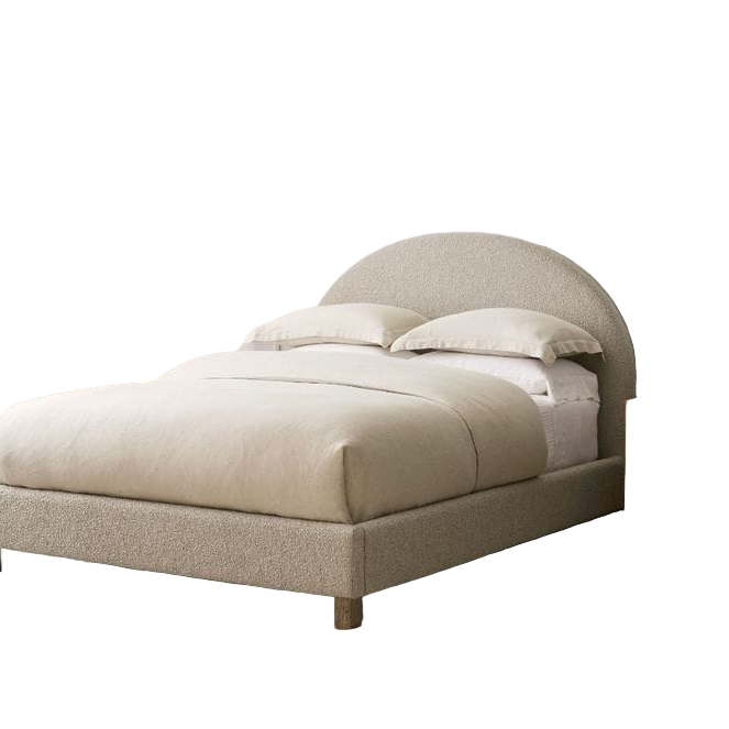 Beige upholstered bed in a bedroom setting with nightstands and artwork.