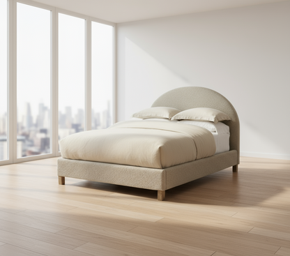 Beige upholstered bed in a bedroom setting with nightstands and artwork.