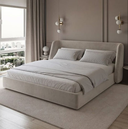 Modern bedroom with a large bed, neutral walls, and decorative elements.