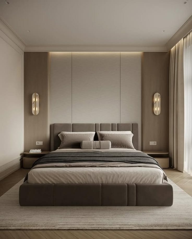 Modern bedroom with a large bed in a neutral color scheme.