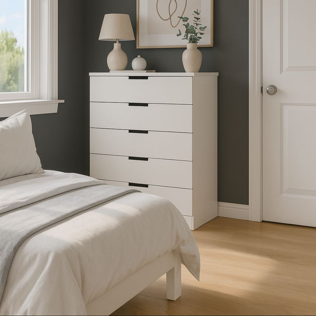 Modern bedroom with white dresser, bed, and framed artwork on a dark gray wall.