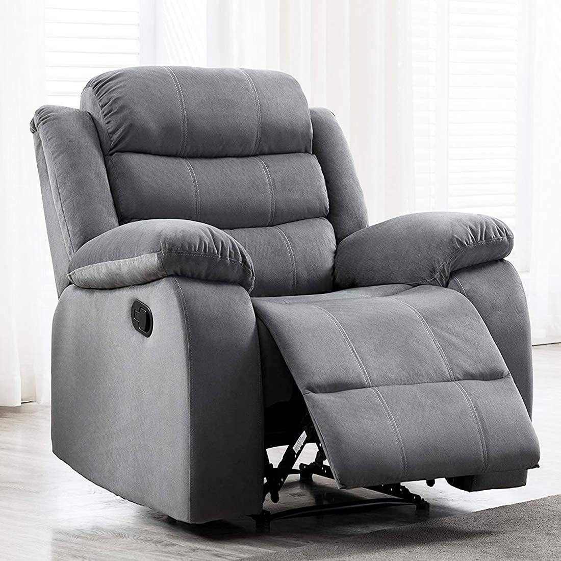 grey recliner chair in a room with light-colored curtains