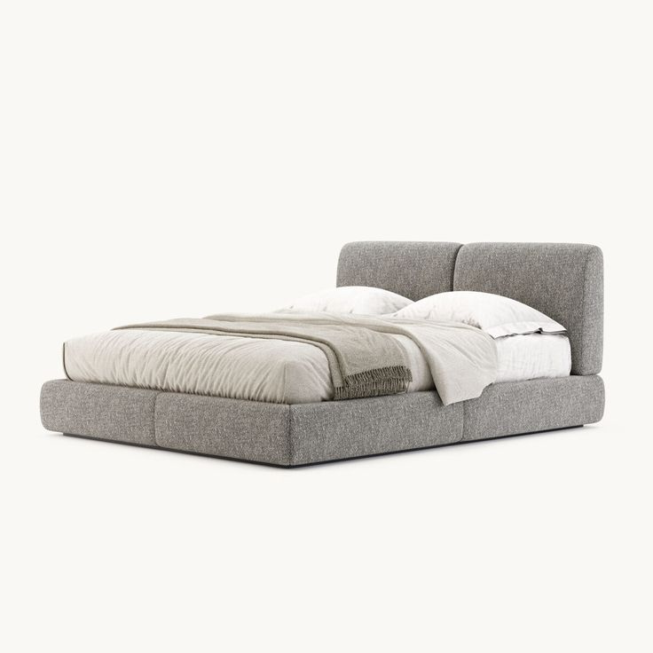 Gray upholstered bed with white bedding on a white background