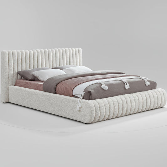 Bed with textured headboard and bedding on a white background