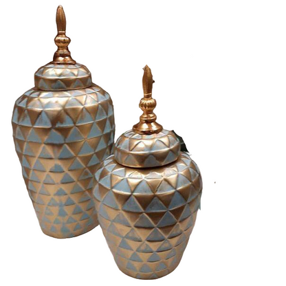 Decorative vases and candle holders with geometric patterns on a table.