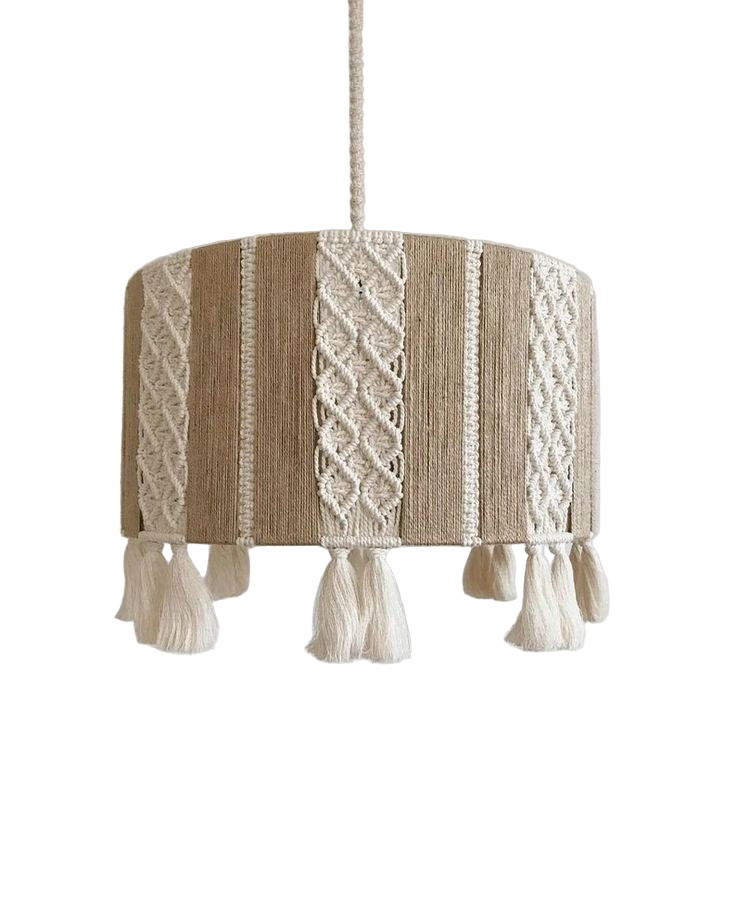 Textured lampshade with macrame design and tassels on a plain background