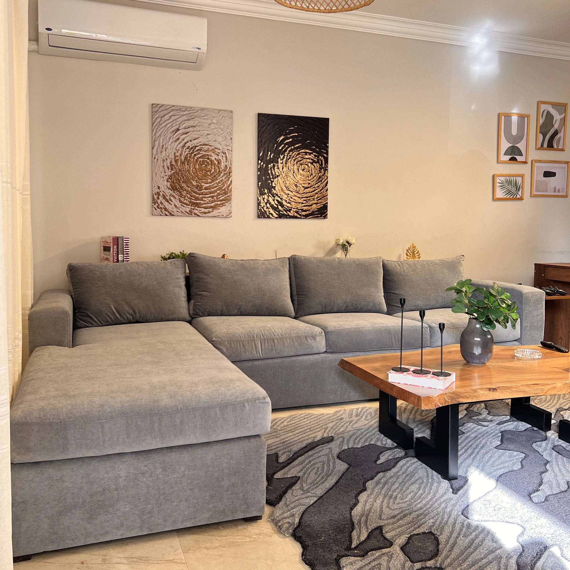 Living room with gray sectional sofa, wooden coffee table, and decorative elements.