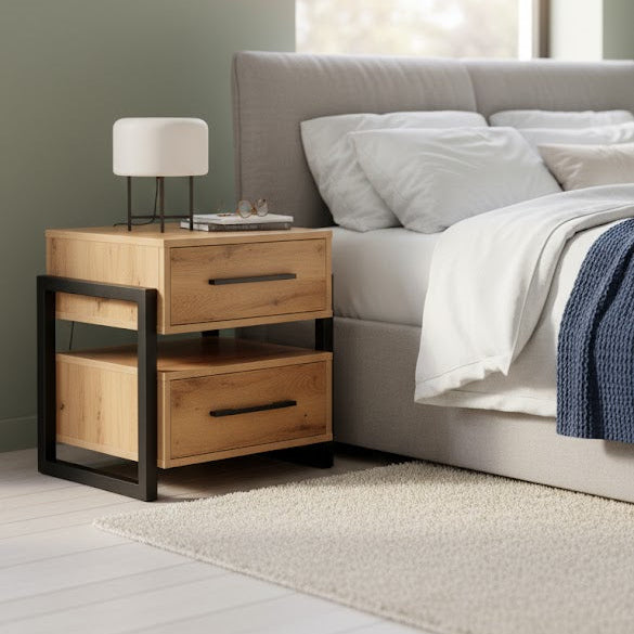 Wooden nightstand with lamp next to a bed in a bedroom setting