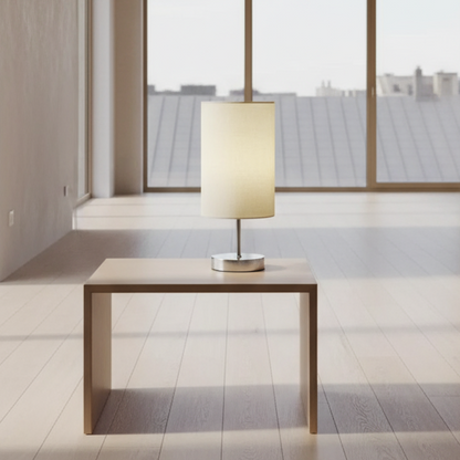 Table lamp with a beige shade on a wooden surface
