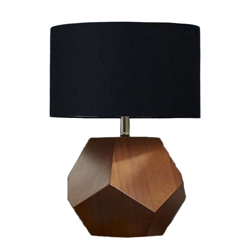 Table lamp with geometric wooden base and black shade on a white pedestal against a dark gray background